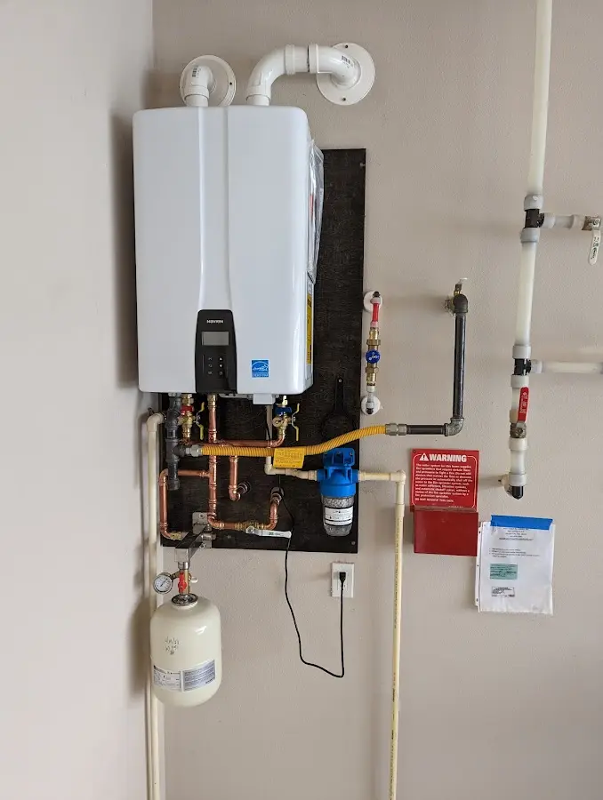 Professional plumber installing copper piping in a Holts Summit home